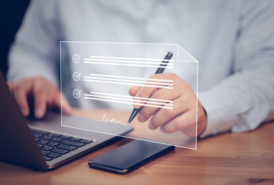 Mann unterschreibt digital am Notebook